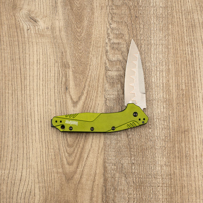 Kershaw Dividend folding pocket knife with a bright green handle and stone-washed steel blade on a wood-grain surface, showcasing its premium craftsmanship and durable design.