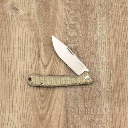 Kershaw Federalist folding pocket knife with a stone-washed stainless steel blade and tan canvas-micarta handle, showcasing classic craftsmanship and American-made quality.