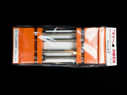 Stone Holder Spring Loaded in packaging, displaying orange clamps with metal rods, springs, and nuts, designed for secure, easy mounting of whetstones.