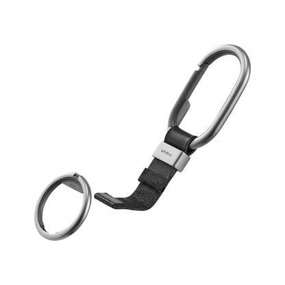 Orbitkey Clip with silver carabiner, black leather strap, and branded metal clasp, showcasing modular design for organized key management. Includes detached matching silver key-ring.