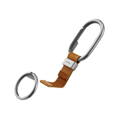 Orbitkey Clip featuring a matte-silver carabiner attached to a brown leather strap with branded metal clamp and matching keyring for organized key carrying.