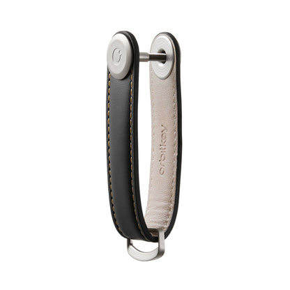 Orbitkey Leather Key Organizer with black and tan leather strap, metal screw post, and D-ring for easy key management, designed for everyday carry.