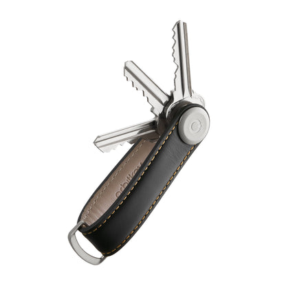 Orbitkey Leather Key Organizer, a sleek leather sheath with pivot bolt, neatly holds 2-7 keys, preventing scratches and offering easy access, enhancing everyday carry efficiency.