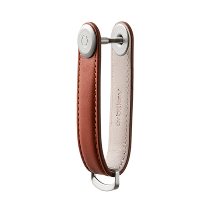 Orbitkey Leather Key Organizer with brown leather strap, stitched edges, and D-shaped metal ring, neatly holds 2-7 keys without scratching other items.