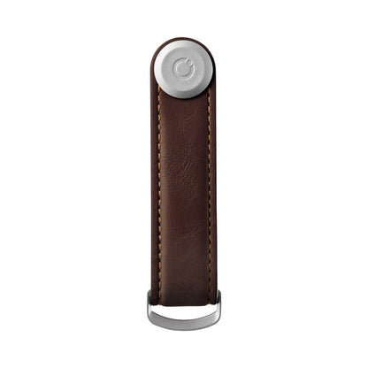 Orbitkey Leather Key Organizer with a brown-leather strap, silver tracking tag holder, and D-shaped ring for attaching keys; a sleek, organized EDC solution.