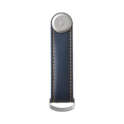 Orbitkey Leather Key Organizer in navy leather, featuring yellow-orange stitching, a silver button, and D-ring clasp, designed for organizing two to seven keys efficiently.