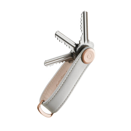 Orbitkey Leather Key Organizer with gray leather and rose-gold hardware, neatly holding four keys, designed for organized, scratch-free everyday carry.