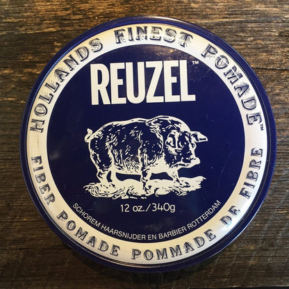Reuzel Fiber Pomade Navy tin, showcasing pig illustration and Holland’s Finest Pomade, offers medium-strong, pliable hold for textured styles on medium to thick hair.