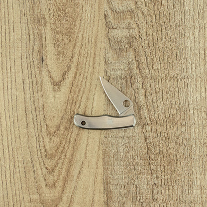 Spyderco Bug Stainless Pocket Knife with slim metal handle, single stainless-steel blade, and thumb-opening hole, open on light wood-grain surface.