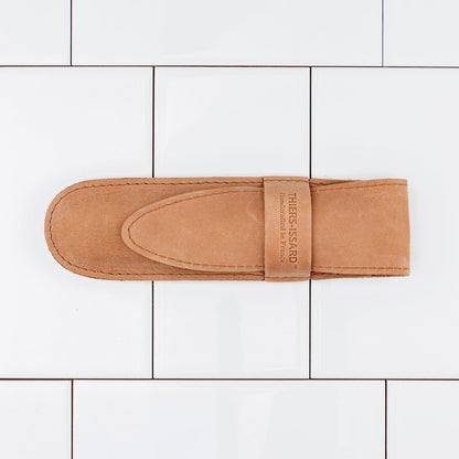 Thiers Issard Straight Razor, Throat Cutter Gold, Ebony, 6/8, showcased in a tan suede sheath embossed with branding, highlighting its premium craftsmanship.