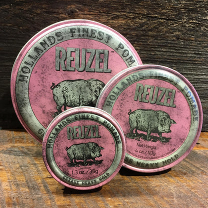 Reuzel Grease Heavy Pink tins in three sizes on wood, showcasing their classic stiff wax pomade for extreme hold and versatile styling.